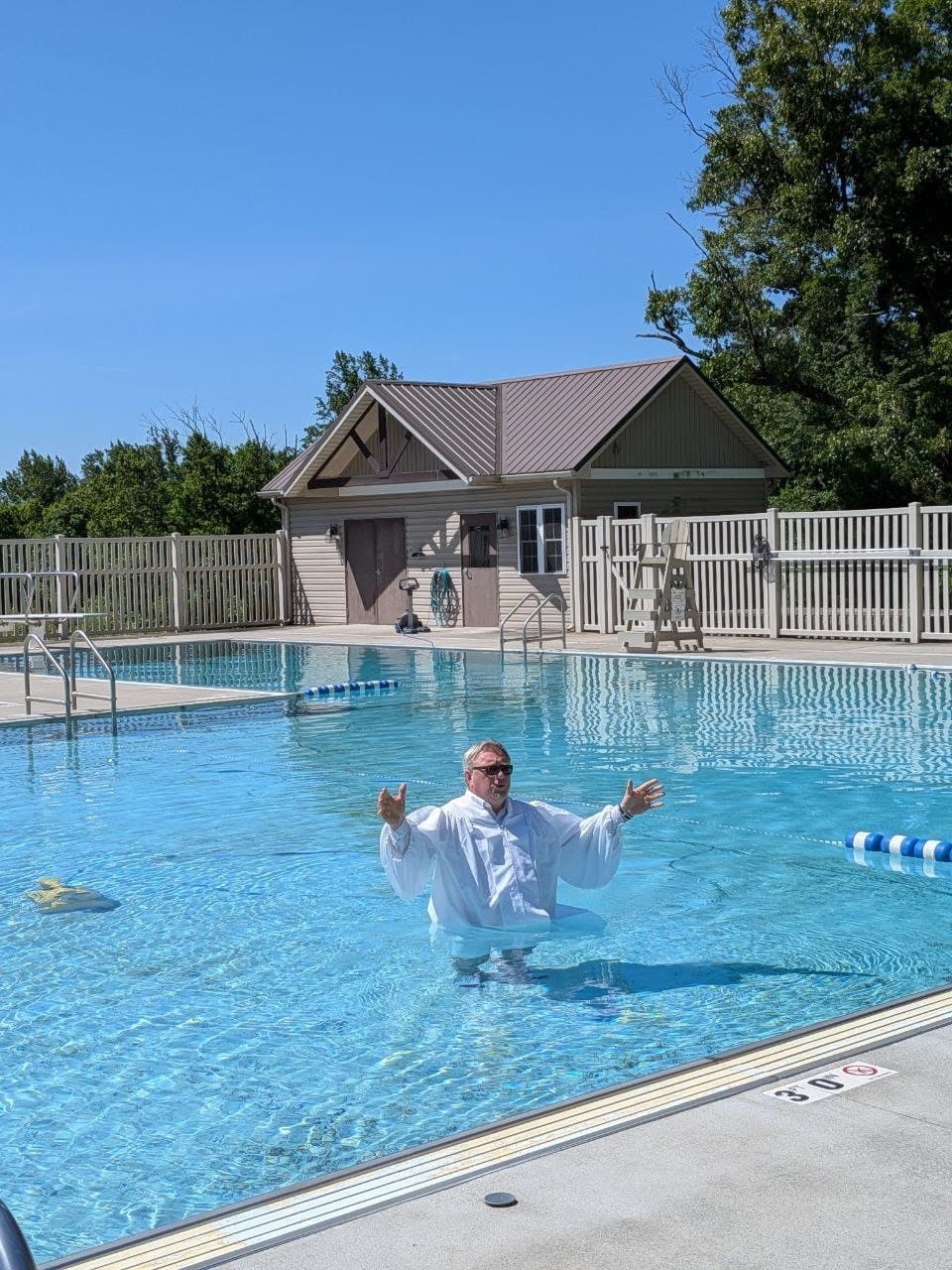 A pastor in the water before the baptism